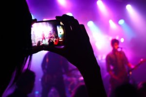live music | live performance in person | girl taking photo of band